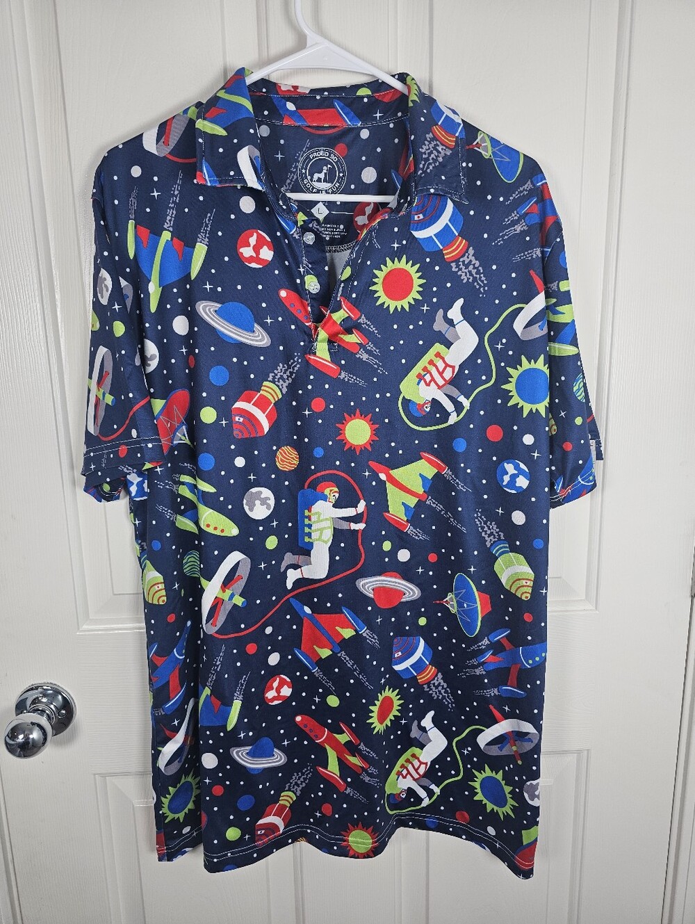 Proud 90 golf polo shirt features a vibrant space-themed Size L